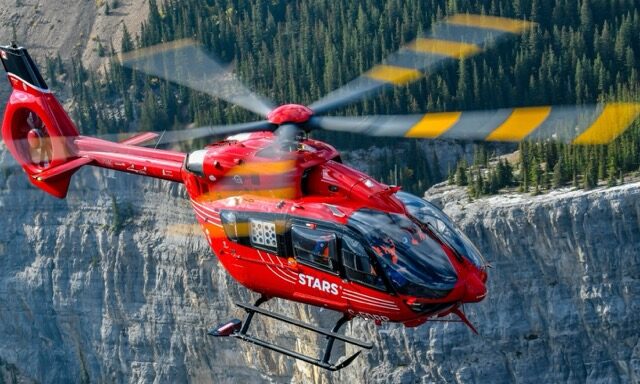 Emergency response helicopter over the mountains